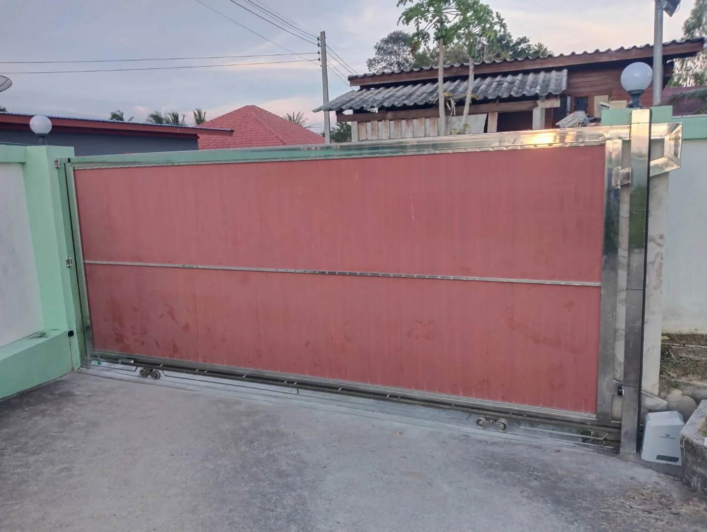 A long sliding gate in a housing estate after installation